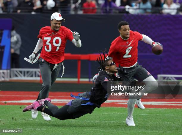 Pat Surtain II of the Denver Broncos and AFC carries the ball after intercepting a pass intended for Justin Jefferson of the Minnesota Vikings and...