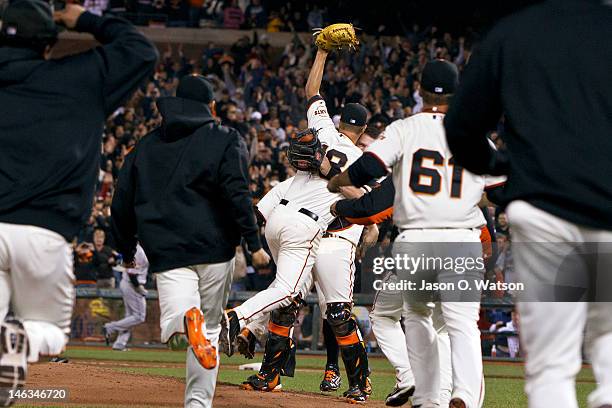 Matt Cain of the San Francisco Giants is congratulated by Buster Posey and teammates after pitching a perfect game against the Houston Astros at AT&T...