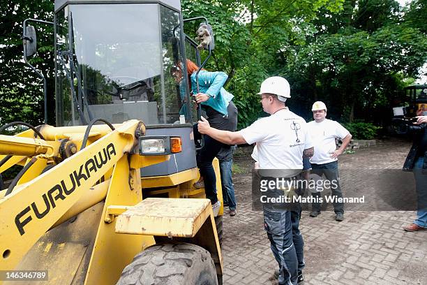Andrea Berg climb on a excavator at the Stups Children Center for the RTL Charity Marathon on June 13, 2012 in Krefeld, Germany.