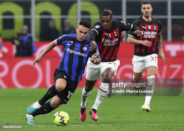 Lautaro Martinez of FC Internazionale competes for the ball with Pierre Kalulu of AC Milan during the Serie A match between FC Internazionale and AC...