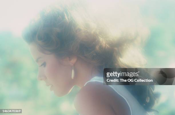 Profile portrait of American model and actress Corinne Alphen as she poses outside, May 1981. The photo was taken as part of her Penthouse magazine...