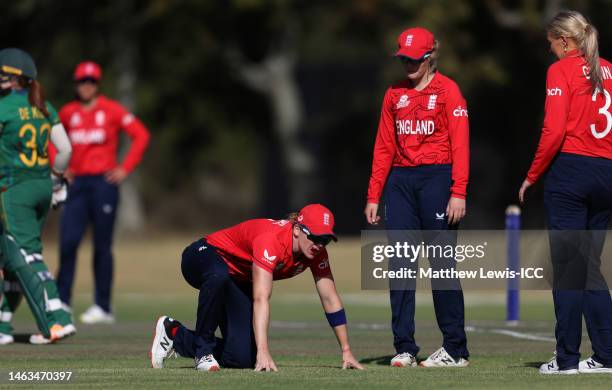 Heather Knight of England reacts after being hit in the mouth from a shot by Nadine de Klerk of South Africa during a warm-up match between South...