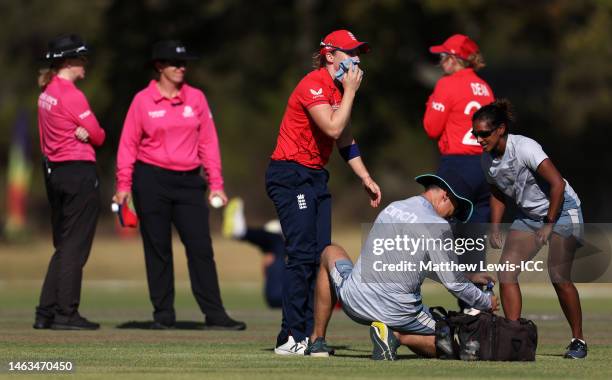 Heather Knight of England reacts after being hit in the mouth from a shot by Nadine de Klerk of South Africa during a warm-up match between South...