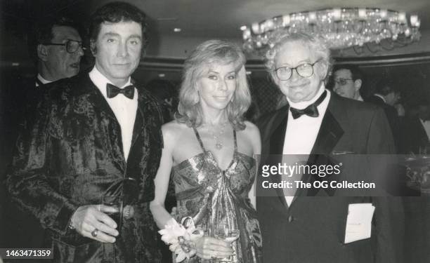 Portrait of, from fore left, magazine publishers and couple Bob Guccione and Kathy Keeton , with photographer Bill Stone, as they pose together...