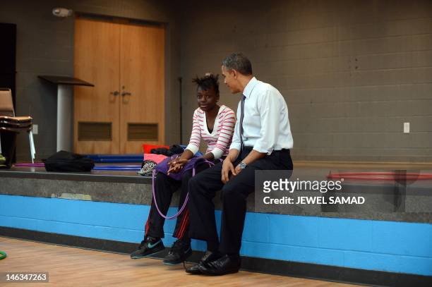 President Barack Obama talks to a girl at the Boys and Girls Club of Cleveland in Cleveland, Ohio, on June 14, 2012. Obama's campaign savagely mocked...