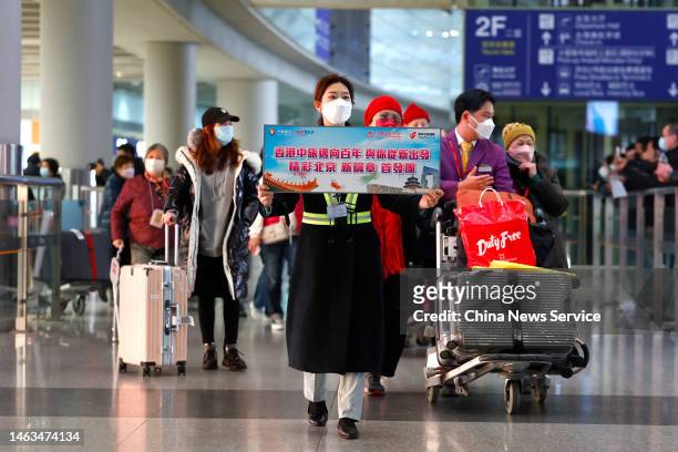 Travellers of a tour group from Hong Kong arrive at Beijing Capital International Airport on February 6, 2023 in Beijing, China. China resumed...
