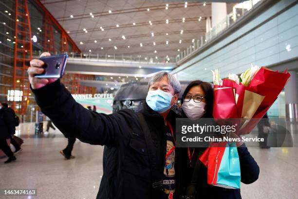 Travellers of a tour group from Hong Kong arrive at Beijing Capital International Airport on February 6, 2023 in Beijing, China. China resumed...