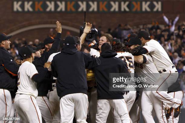 Matt Cain of the San Francisco Giants is congratulated by teammates after pitching a perfect game against the Houston Astros at AT&T Park on June 13,...