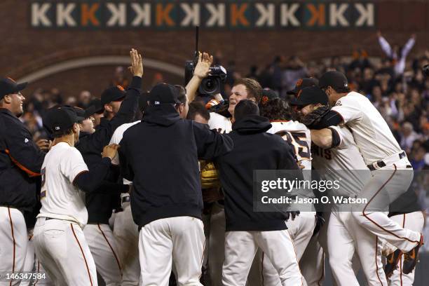 Matt Cain of the San Francisco Giants is congratulated by teammates after pitching a perfect game against the Houston Astros at AT&T Park on June 13,...