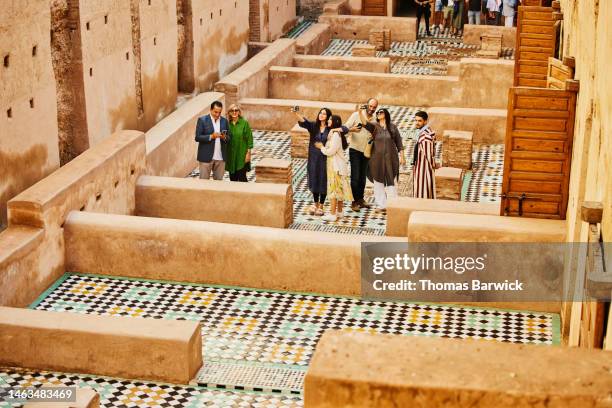 wide shot of tour guide leading group on tour of el badi palace - free mosaic patterns fotografías e imágenes de stock