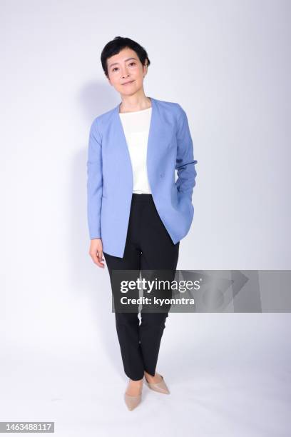 full body portrait of a middle-aged asian woman - woman standing full body isolated stock pictures, royalty-free photos & images