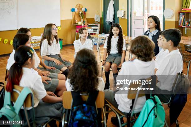 students and teacher doing relaxation exercises - connected mindfulness work stock pictures, royalty-free photos & images