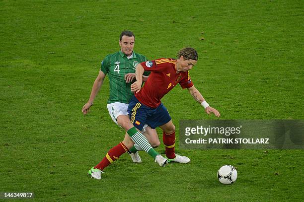 Irish defender John O'Shea vies with Spanish forward Fernando Torres during the Euro 2012 championships football match Spain vs Republic of Ireland...