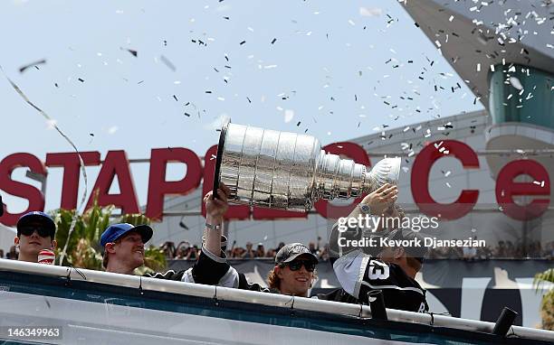 Los Angeles Kings team members from Jonathan Quick, Matt Greene, Anze Kopitar and Dustin Brown hold the Stanley Cup to cheering fans during the...