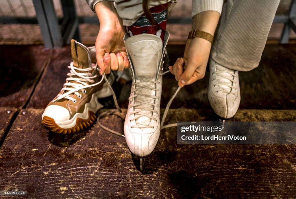 Female hands tying shoelaces of ice skates