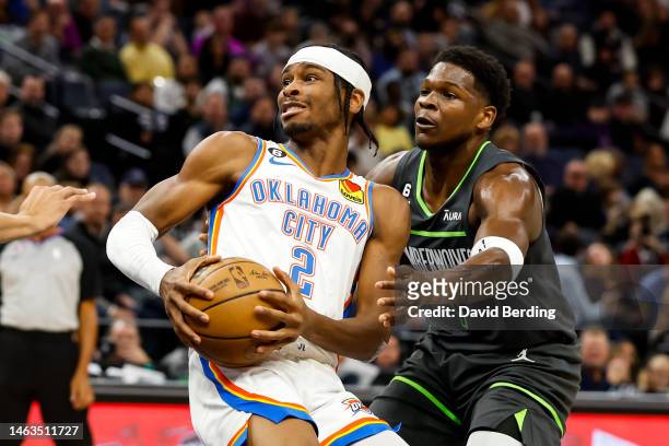 Shai Gilgeous-Alexander of the Oklahoma City Thunder in action while Anthony Edwards of the Minnesota Timberwolves defends in the third quarter of...