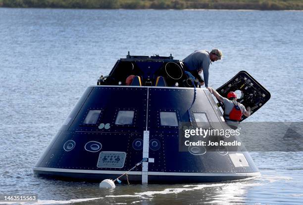 Members of the US Navy and NASA Landing and Recovery Team practice retrieving astronauts from a test version of the Orion capsule on February 06,...