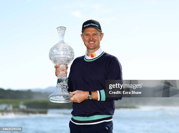 Justin Rose of England poses with the trophy on the 18th green during the continuation of the final round of the AT&T Pebble Beach Pro-Am at Pebble...