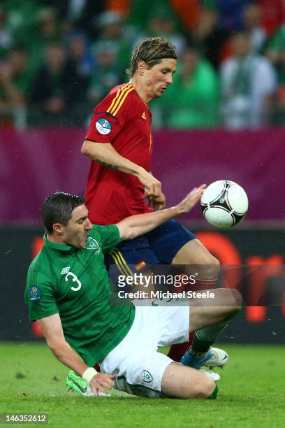 Fernando Torres of Spain clashes with Stephen Ward of Republic of Ireland during the UEFA EURO 2012 group C match between Spain and Ireland at The...