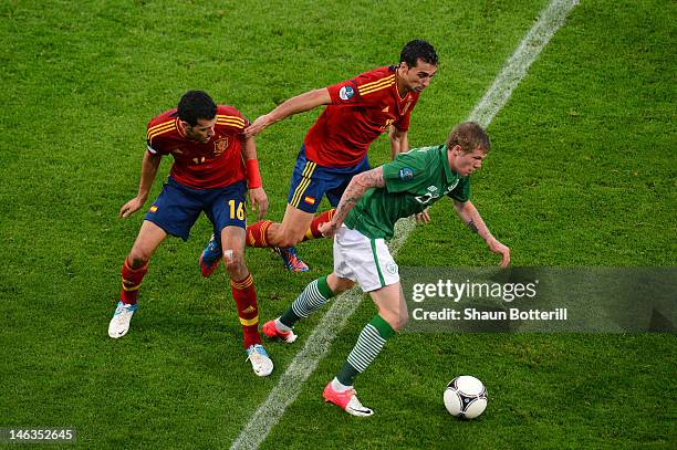 James McClean of Republic of Ireland is put under pressure by Sergio Busquets of Spain during the UEFA EURO 2012 group C match between Spain and...