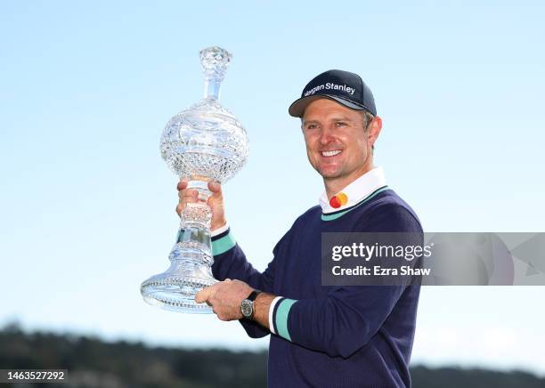 Justin Rose of England poses with the trophy on the 18th green during the continuation of the final round of the AT&T Pebble Beach Pro-Am at Pebble...