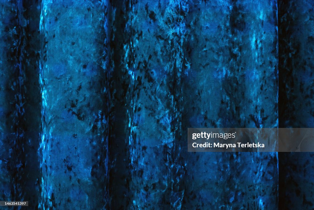 Universal background with velor blue fabric. Fabric background.
