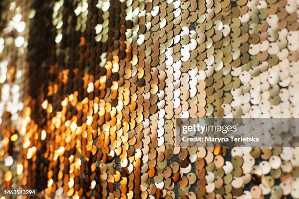 beautiful universal background with gold color sequins. festive background. christmas. birthday. - sequin stock-fotos und bilder