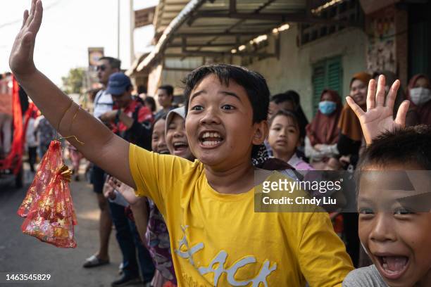 Children cheer during a procession of spirits on February 06, 2023 in Phnom Penh, Cambodia. The annual Hei Neak Ta, or procession of spirits, marks...