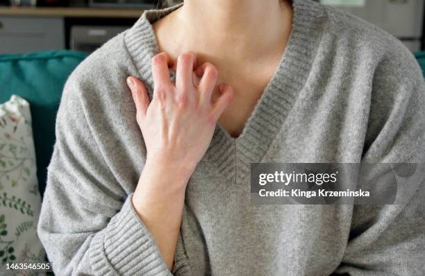scratching neck - tiroide foto e immagini stock