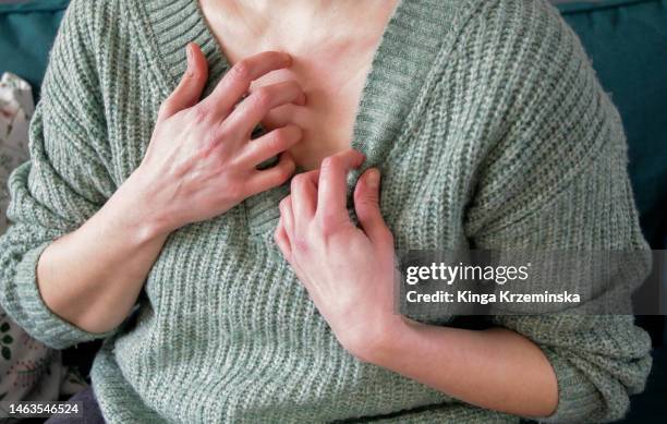 scratching chest - menopausa foto e immagini stock
