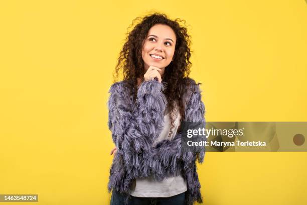 portrait of a beautiful dark-skinned young woman on a bright background. beautiful curly girl. emotional photo. - camicia di paillette foto e immagini stock