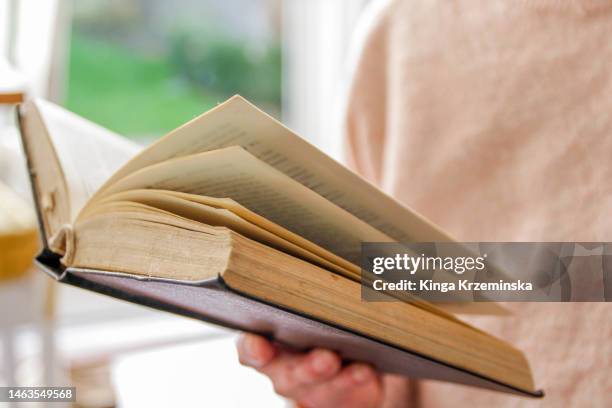 reading a book - poetry reading stock pictures, royalty-free photos & images