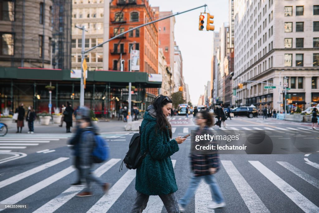 Commuter checking apps on the streets of NYC