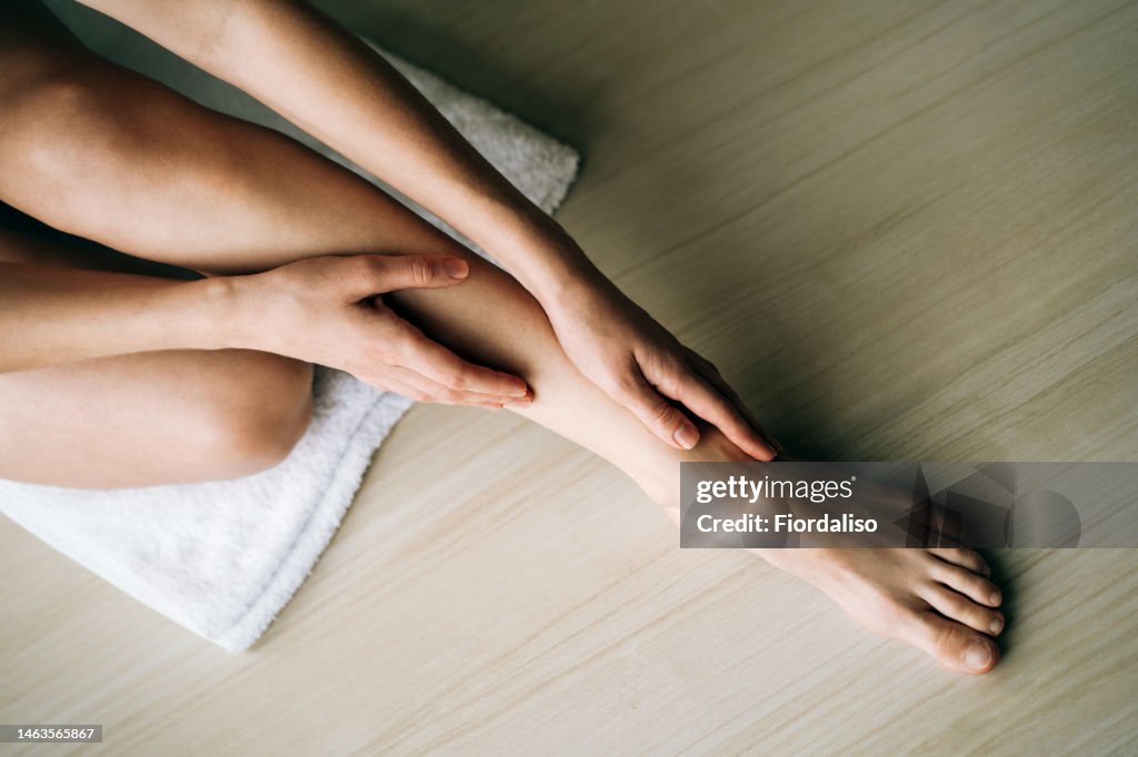 Woman massaging her legs