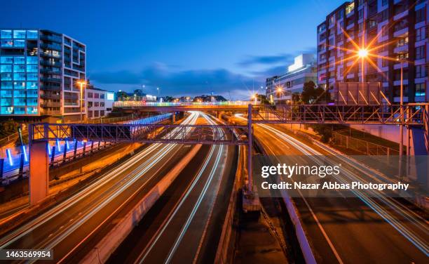 the light trails of car lights on a multi-lane highway - auckland traffic stock pictures, royalty-free photos & images