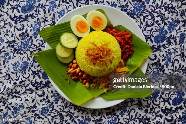 nasi kuning or yellow rice or tumeric rice is traditional food from asia,made rice cooked with turm,giurgiu,romania - traditional malay food stock pictures, royalty-free photos & images