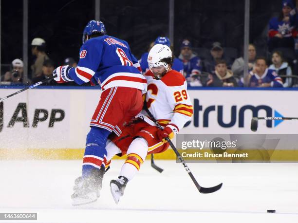 Jacob Trouba of the New York Rangers steps into Dillon Dube of the Calgary Flames during the first period at Madison Square Garden on February 06,...
