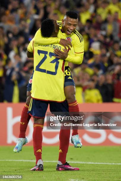 Oscar Cortes and Jorge Cabezas Hurtado of Colombia celebrate the first goal of the team by an own goal of Luis Mina of Ecuador during a South...