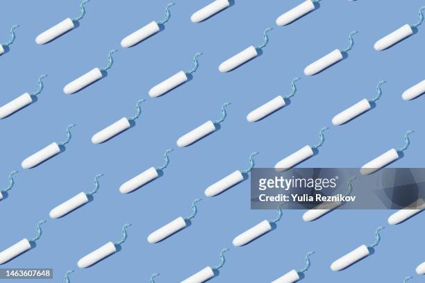 repeated tampons on the blue background - tampon stock pictures, royalty-free photos & images