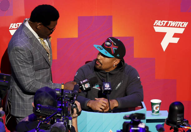 Commentator Michael Irvin talks with Jalen Hurts of the Philadelphia Eagles during Super Bowl LVII Opening Night presented by Fast Twitch at...