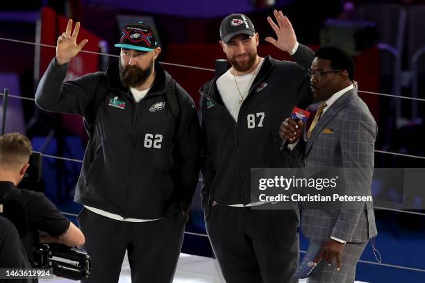 Brothers Jason Kelce of the Philadelphia Eagles and Travis Kelce of the Kansas City Chiefs wave onstage during Super Bowl LVII Opening Night...