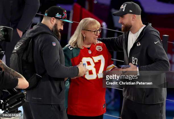Mother Donna Kelce gives cookies to her son's Jason Kelce of the Philadelphia Eagles and Travis Kelce of the Kansas City Chiefs during Super Bowl...