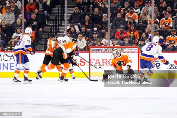 Mathew Barzal of the New York Islanders scores past Carter Hart of the Philadelphia Flyers during the second period at Wells Fargo Center on February...