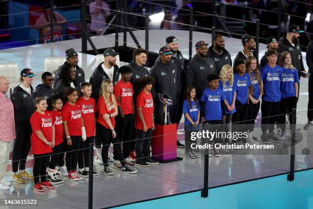 Patrick Mahomes and Jalen Hurts of the Philadelphia Eagles stand with their teams onstage during Super Bowl LVII Opening Night presented by Fast...