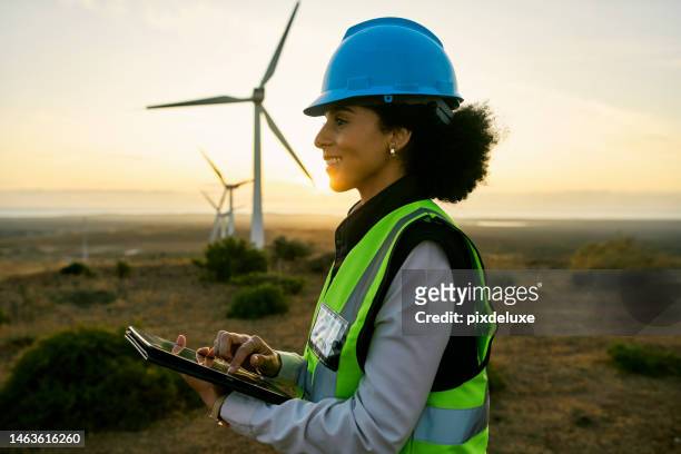 engineer woman, tablet and windmill for renewable energy, power and electricity innovation. electrician or technician person in sunset nature for wind turbine and eco environment future maintenace - wind mill stockfoto's en -beelden