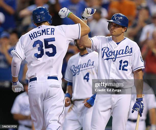 Eric Hosmer of the Kansas City Royals is congratulated by Mitch Maier after hitting a two-run home run during an interleague game against the...