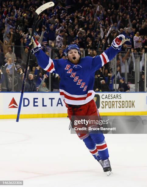 Alexis Lafreniere of the New York Rangers celebrates his game-winning overtime goal against the Calgary Flames at Madison Square Garden on February...