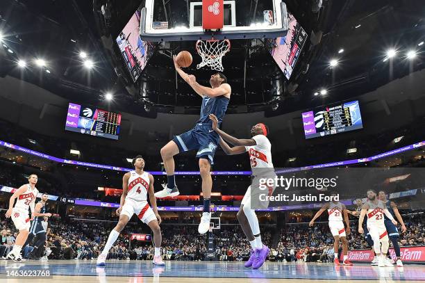 Santi Aldama of the Memphis Grizzlies dunks against Chris Boucher of the Toronto Raptors at FedExForum on February 05, 2023 in Memphis, Tennessee....