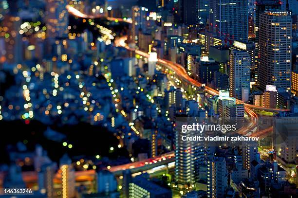 illuminated of tokyo cityscape - tilt shift stock pictures, royalty-free photos & images