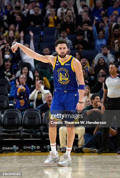 Klay Thompson of the Golden State Warriors reacts after making a three-point shot against the Oklahoma City Thunder during the third quarter at Chase...